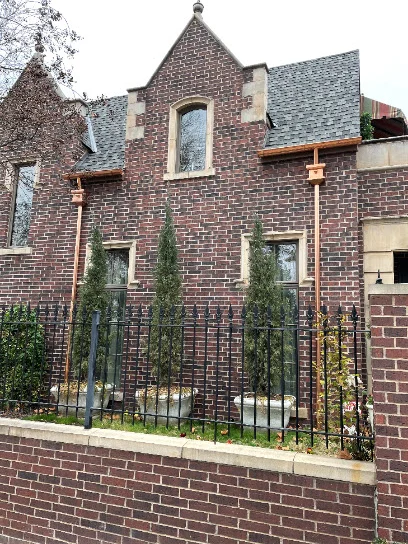 Copper gutter and downspout detail on a brick home