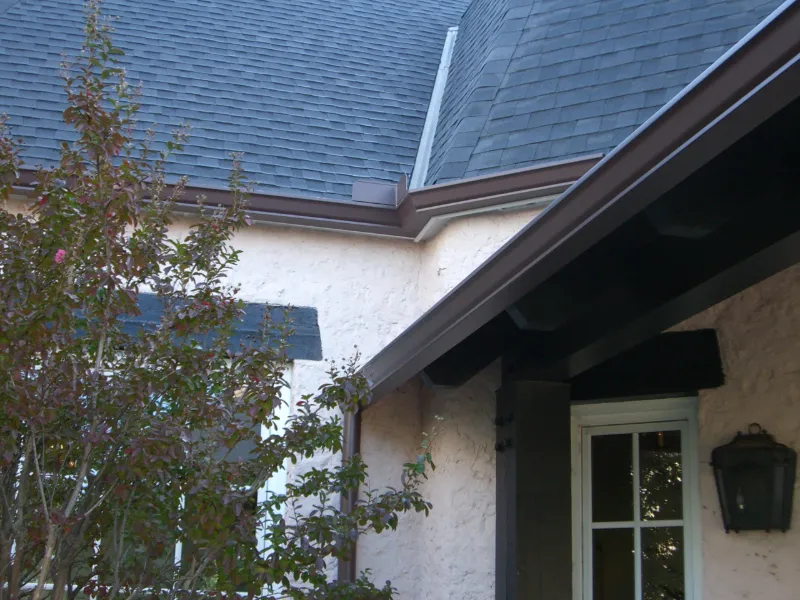 Wilco Guttering completed brown gutters on a stucco home in Tulsa